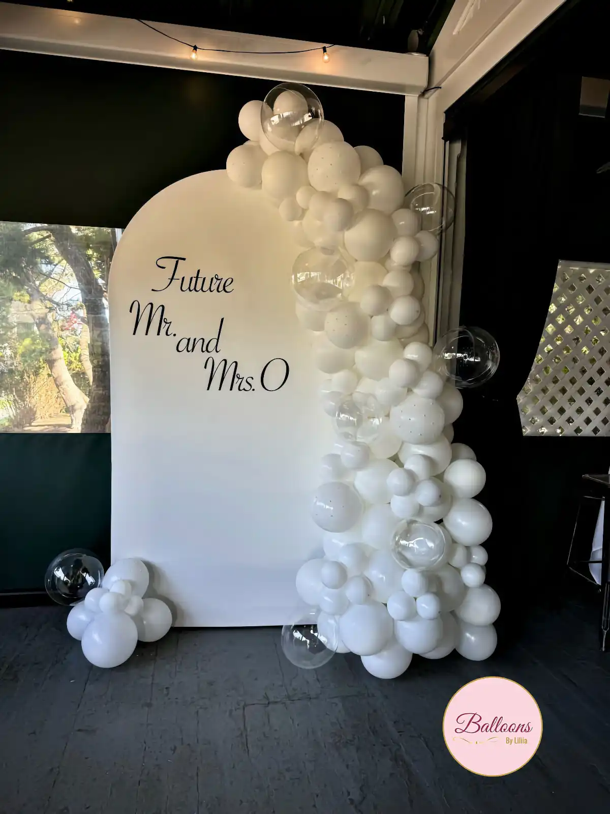 backyard bridal shower balloon setup with backdrop