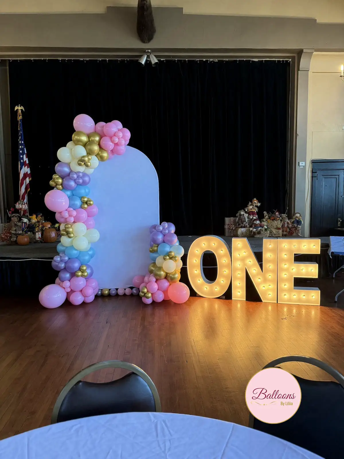 first birthday balloon setup with neutral colors